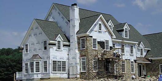 House under construction wrapped in tyvek